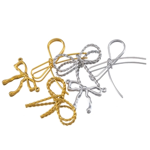 Macro detail of assorted gold and silver stainless steel butterfly charms for jewelry making