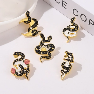 Detailed view of 5 gothic snake enamel pins featuring skulls, roses and dark mystic symbols