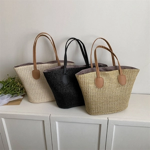Large straw beach tote bags in cream, black, and khaki with durable leather handles