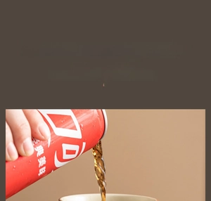 Macro shot of ceramic tea cup with hand-painted glaze being filled with cola