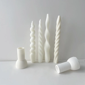 Detailed view of spiral twist pillar candles with white ceramic candle holders