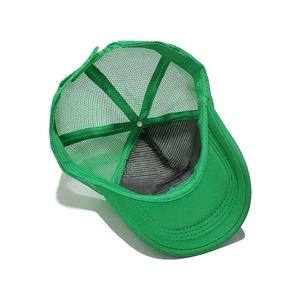 Detail view of the breathable green mesh back and interior structure of the trucker hat