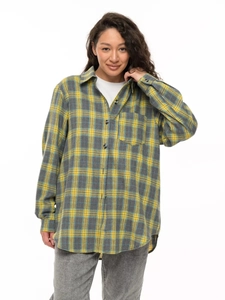 Detail shot of yellow and grey flannel plaid shirt showing button-down front and pocket