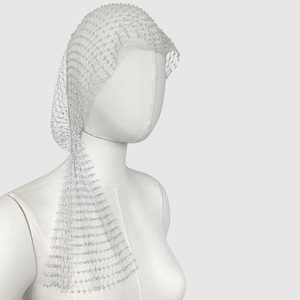 Detail of white mesh bridal headpiece with sparkling crystals and elegant pearl fringe
