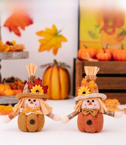 Detail of harvest gnomes with pumpkin body, maple leaf, and sunflower decor for Thanksgiving