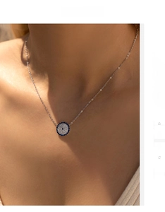 Detailed view of S925 silver evil eye pendant with blue and white zircon stones