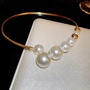 French style gold choker necklace with graduated white pearls and geometric metal band