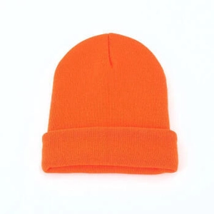 Close-up of bright orange knitted beanie hat featuring high-visibility ribbed texture