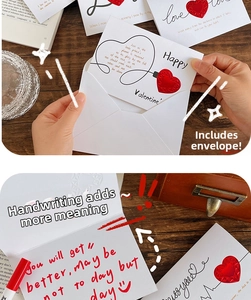 Close-up of handwriting on a 3D heart greeting card set with a red pen and envelope