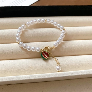 Detail of freshwater pearl bracelet with watermelon charm in premium jewelry box display