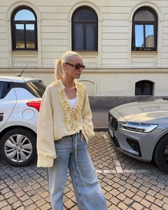 Close-up of ruffled pale yellow blouse collar with street style fashion aesthetics