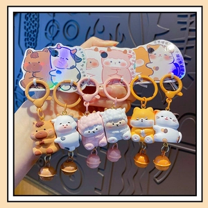 Detailed view of six cute animal resin keychains with colorful bells and art backing cards