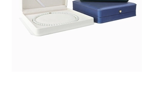 Macro view of luxury pearl necklace jewelry box with velvet interior and crown detail