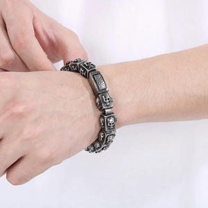 Men's vintage stainless steel skull link bracelet with gothic relief and distressed finish