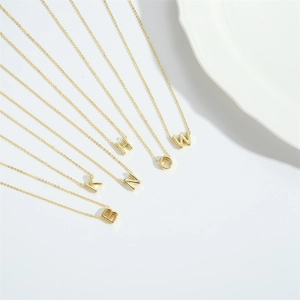 Elegant gold letter necklaces with delicate cross chain design on a white background