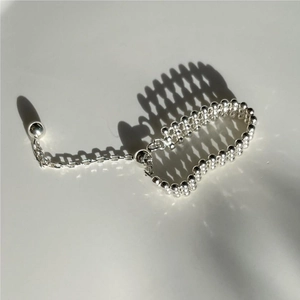 Close-up of a minimalist 925 silver beaded bracelet with adjustable chain and pendant