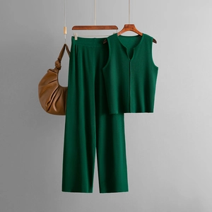 Detail of dark green knitted set featuring a V-neck sleeveless top and wide-leg trousers