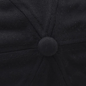Top macro view of black baseball cap showing six-panel structure and fabric texture