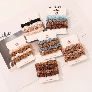 Detailed view of 24-piece satin scrunchies set in assorted colors on display cards