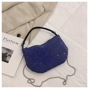 Detail of royal blue rhinestone hobo bag with silver chain strap and leather handle