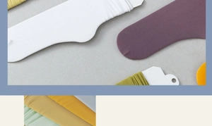 Detailed view of vertically ribbed knit socks in white, purple, yellow, and light green