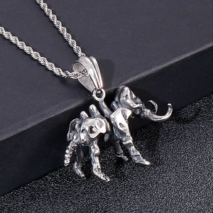 Macro detail of a vintage mammoth skeleton pendant in silver-tone steel with twist chain