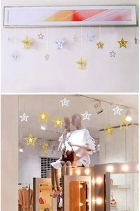 Close-up of 3D hollow star pendants in gold and white for festive ceiling decoration