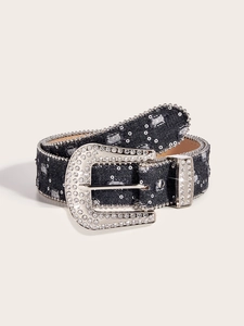 Detailed view of dark blue denim belt with sparkling rhinestones and silver buckle