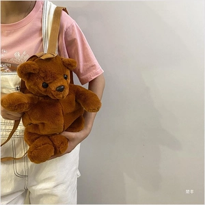 Detailed view of the soft brown plush bear backpack with adjustable shoulder straps