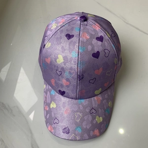 Detail view of purple metallic baseball cap featuring colorful heart prints on top