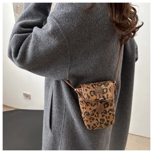 Detail showing leopard print phone bag on model wearing grey wool coat for daily styling