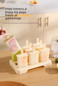 Home popsicle mold set with eight compartments and fresh fruit ice pops on a base