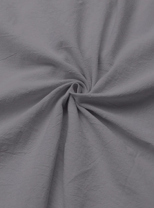 Close-up of gray linen fabric texture with natural draped folds and breathable weave pattern