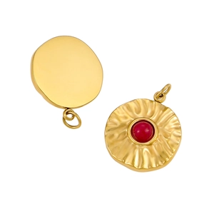 Macro detail of gold-plated stainless steel pendant with red gemstone and ripple texture