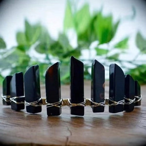 Detail of handcrafted black crystal crown with intricate silver wire weaving on wood