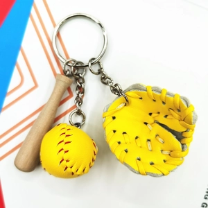 Detailed close-up of a baseball keychain set with wood bat, yellow glove, and ball