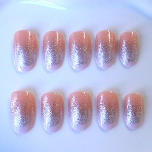 Pink nude oval press-on nails with silver glitter gradient and glossy finish