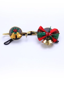 Detail of Christmas themed eyewear with gold metal frame and red plaid bow decoration