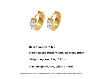 Detailed close-up of gold plated stainless steel hoop earrings with cubic zirconia stones