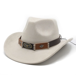 Close-up of decorative leather band with metal bullhead logo on suede western cowboy hat