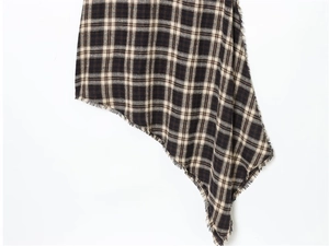 Detail of V-neck plaid dress fabric with black brown check and handmade fringe trim
