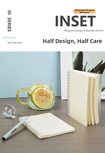 Detail showing translucent frosted PP cover and sturdy dual metal coil binding on notebook