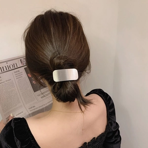 Minimalist silver matte metal hair tie accessory shown on ponytail for women