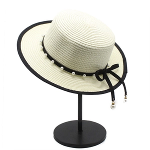 Elegant ivory boater hat with black ribbon, pearl accents and vintage French style