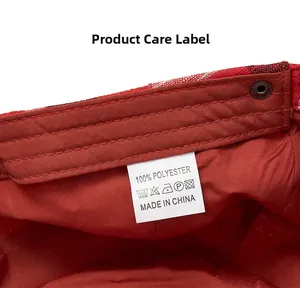 Macro shot of 100% polyester care label and red plaid texture on this newsboy cap
