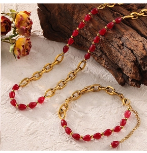 Close-up of red garnet beads and gold-plated chain on vintage necklace set