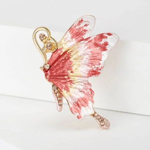 Detail of pink enamel butterfly brooch with gold plating and sparkling crystals