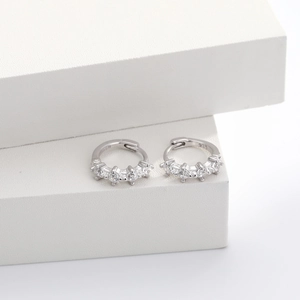 Macro detail of S925 sterling silver hoop earrings with clear cubic zirconia stones