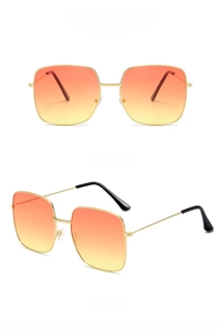 Detail view of retro square gold metal sunglasses with orange to yellow gradient lenses