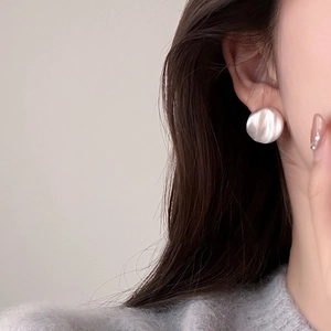 Textured silver geometric round stud earrings with a brushed metal finish for women